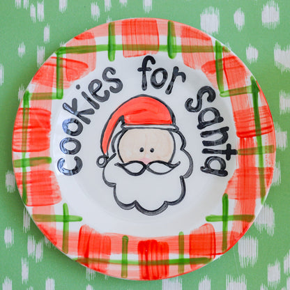 Decorative plate with 'Cookies for Santa' text and Santa Claus illustration on a green background.